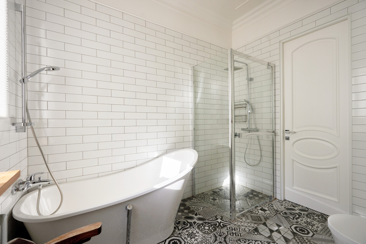 An Elegant And Modern Bathroom Featuring A Luxurious Freestanding Bathtub Along With A Stylish Shower Space